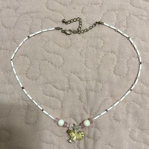 Angel with a trumpet necklace, white and pink. Semi choker